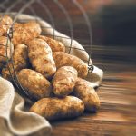 Raw Potatoes Pouring onto The Floor From a Basket.