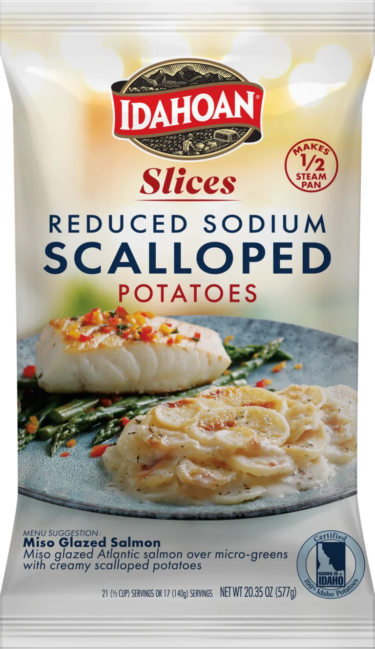 A package of Idahoan Scalloped Potatoes, featuring reduced sodium content, showcases an appetizing image of scalloped potatoes paired with fish and greens, along with text highlighting the recipe suggestion and health-conscious benefits.